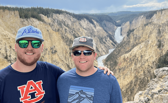 Two brothers pose at Artist Point, Yellowstone Falls. taken on a Teton Excursions tour to Yellowstone National Park