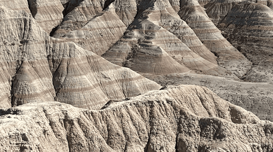 Badlands with multiple layers of rock stretch into the distance. taken on a Teton Excursions tour to Badlands National Park