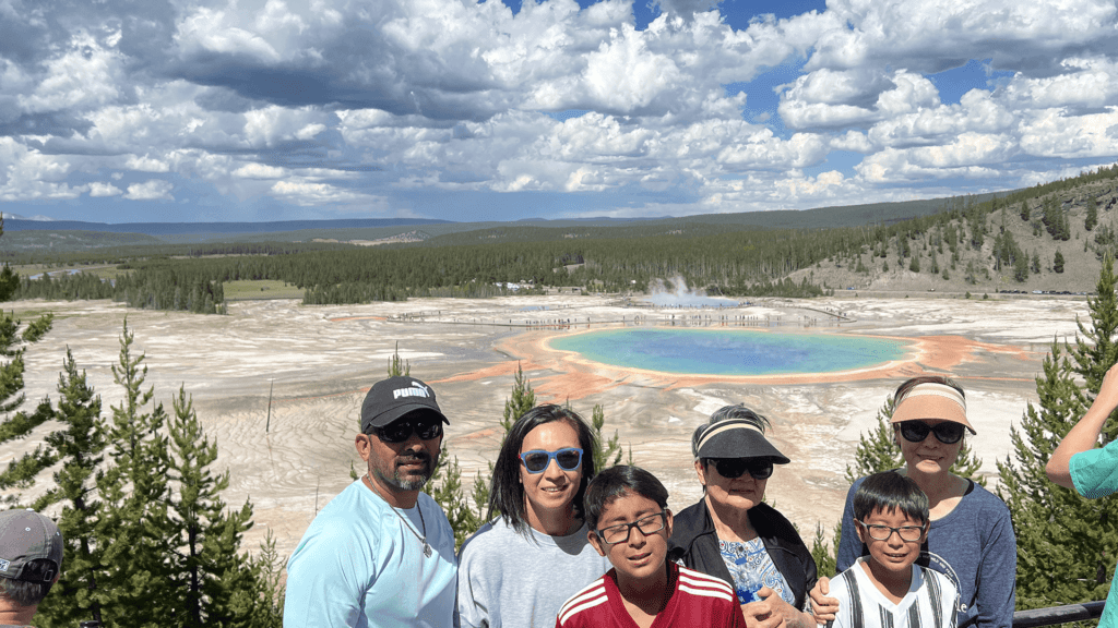 A multi-generation family poses at Grand Prismatic Overlook in Yellowstone National Park. Taken on a Teton Excursions tour of Yellowstone National Park.