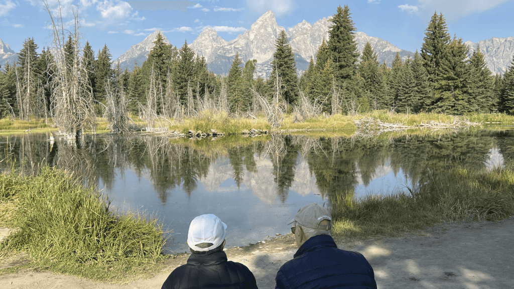 An elderly couple sits and enjoys Schwabacher's Landing in Grand Teton National Park. Taken on a Teton Excursions tour of Grand Teton National Park.