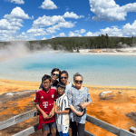 Mulit-generation family poses in front of Sunset Lake, Yellowstone National Park, taken on a Teton Excursions tour to Yellowstone National Park